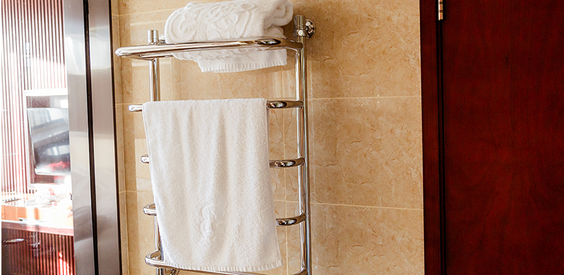 Heated towel rack with elegant design installed in a modern, luxurious bathroom